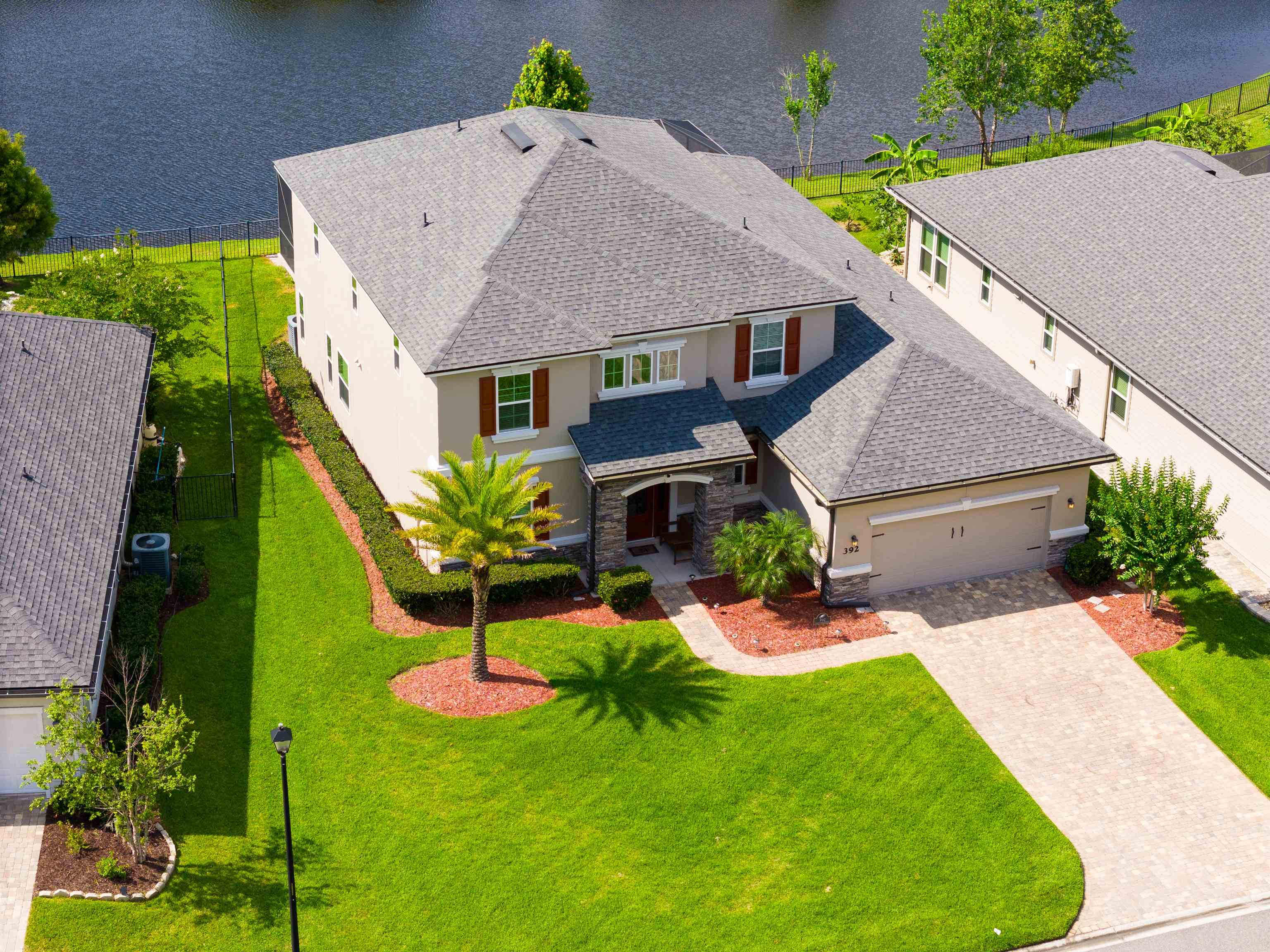 392 Downs Corner Road St. Augustine, FL 32092 - Photo 54 of 55 a view of a house with a yard potted plants and a table