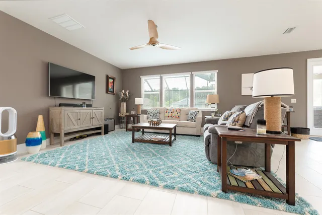 a large bedroom with furniture and flat screen tv