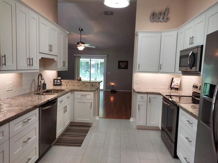 127 Cowry Road St. Augustine, FL 32086 - Photo 8 of 24 a kitchen with a sink stove and microwave