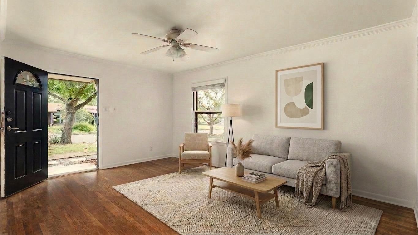 206 East Skyview Road Austin, TX 78752 - Photo 2 of 32 Rich hardwood floors welcome you into this inviting living area, bathed in natural light from a well-placed window.