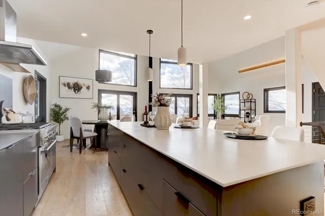 a kitchen with stainless steel appliances granite countertop a sink counter space and living room view