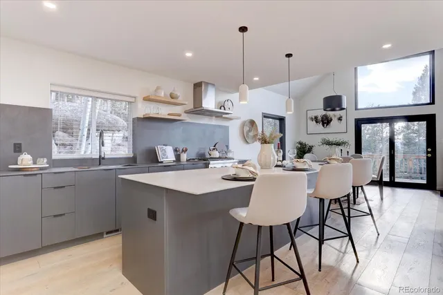 a kitchen with stainless steel appliances kitchen island granite countertop a sink and cabinets