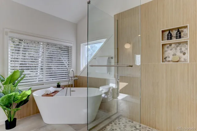 a living room with a couch and a potted plant