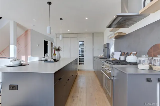 a kitchen with stainless steel appliances a sink stove and cabinets