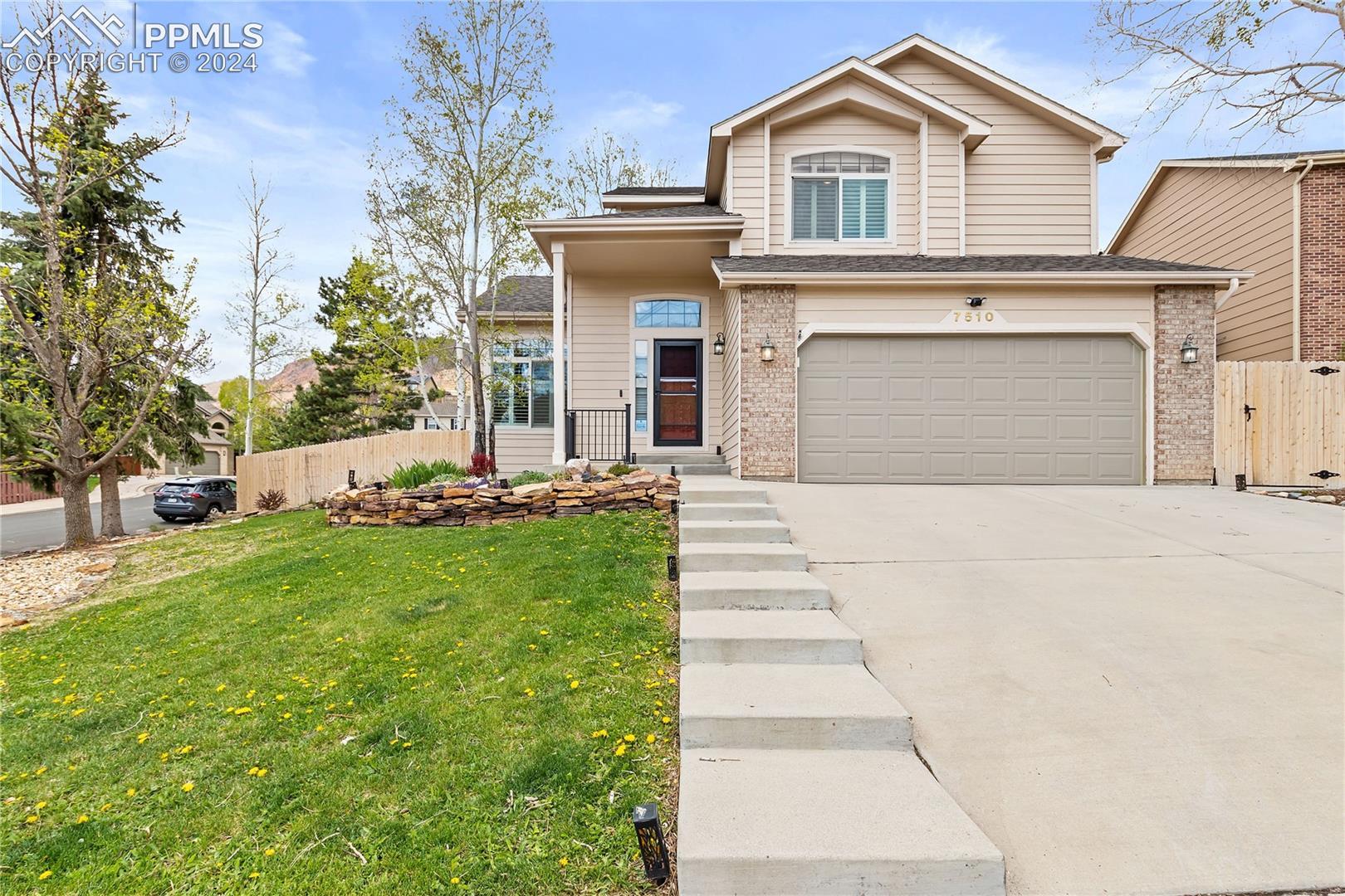 7510 Julynn Road Colorado Springs, CO 80919 - Photo 1 of 36 View of front facade featuring a garage and landscaping