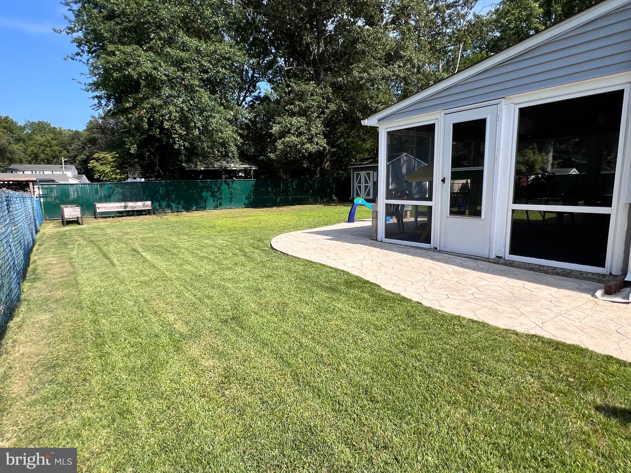 216 Fenimore Lane Delanco, NJ 08075 - Photo 23 of 25 a view of a backyard with table and chairs and wooden fence