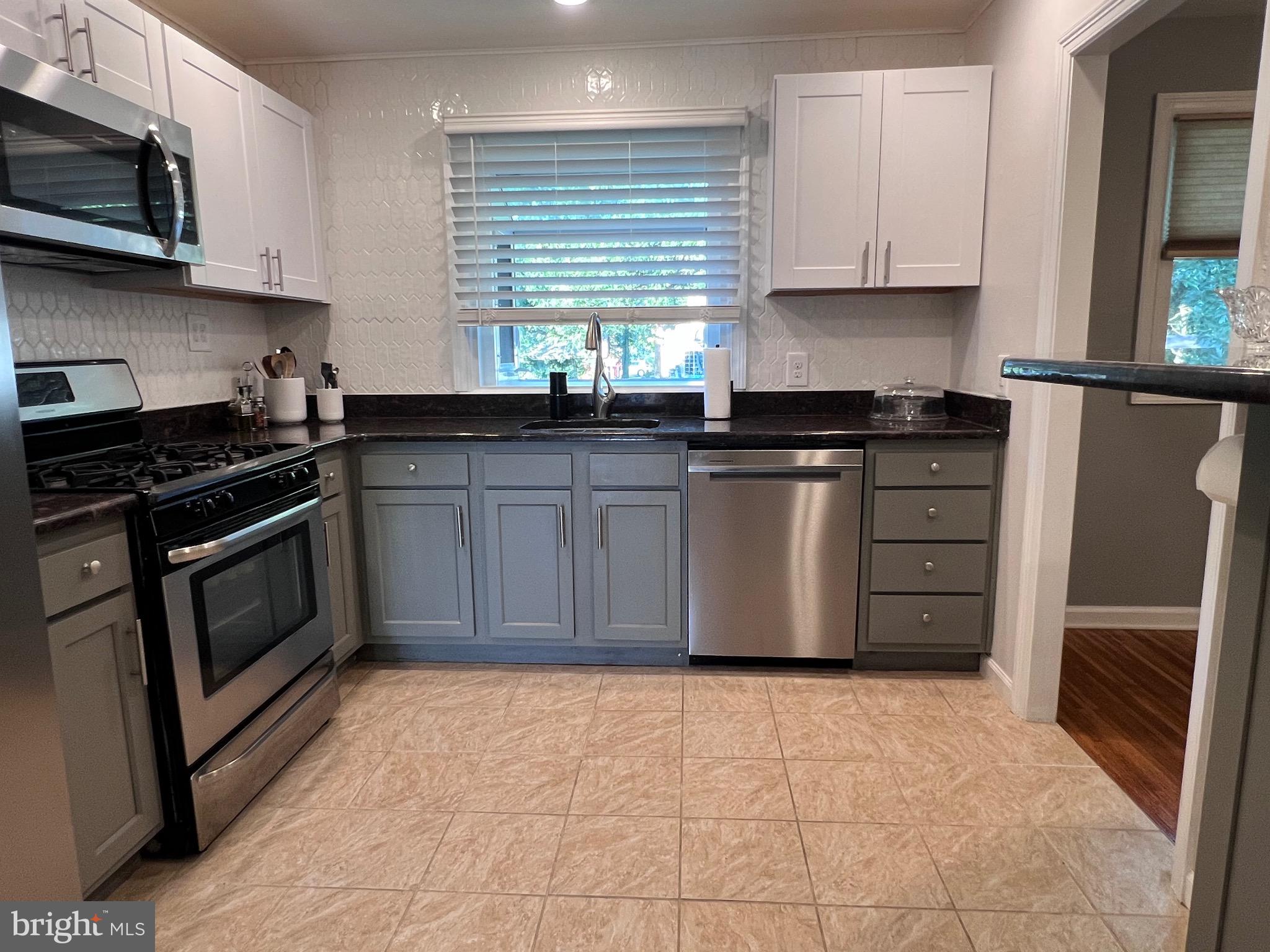 216 Fenimore Lane Delanco, NJ 08075 - Photo 5 of 25 a kitchen with stainless steel appliances granite countertop a stove microwave and cabinets