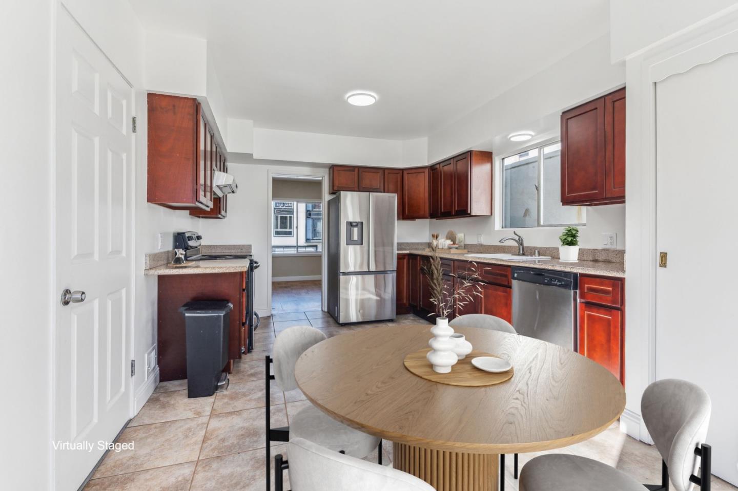 136 Chester Street Daly City, CA 94014 - Photo 15 of 48 a kitchen with stainless steel appliances granite countertop a sink a stove a microwave a dining table and chairs