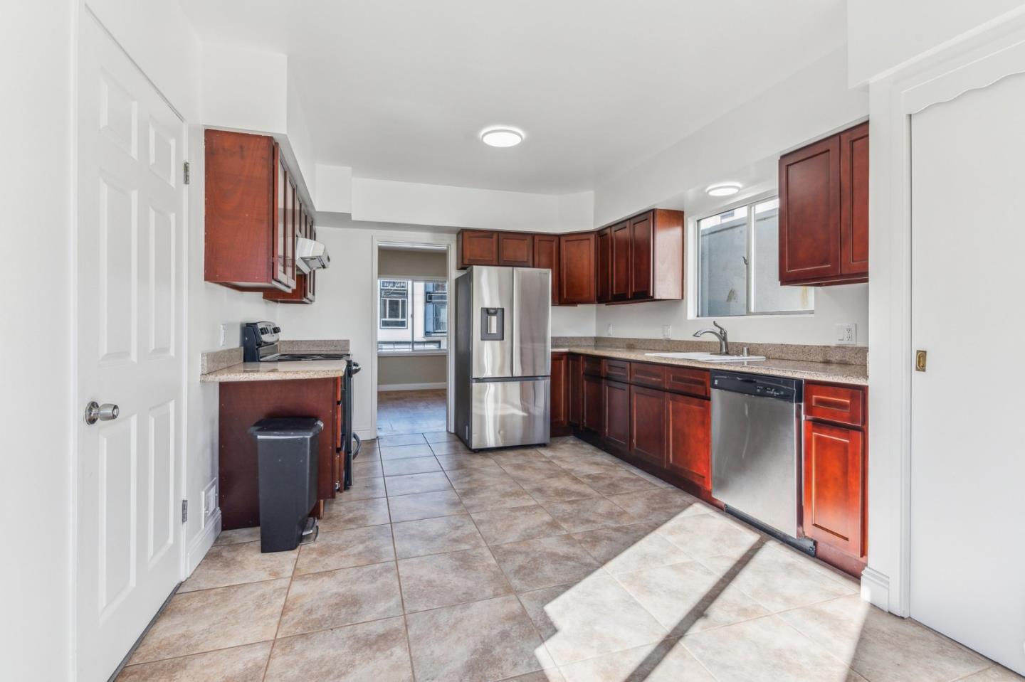 136 Chester Street Daly City, CA 94014 - Photo 16 of 48 a kitchen with stainless steel appliances granite countertop a sink stove and refrigerator