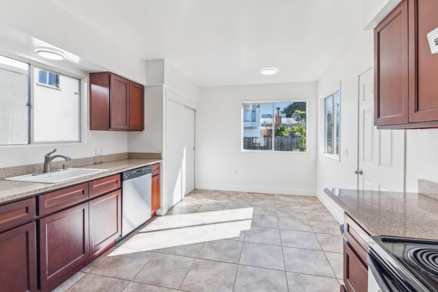 136 Chester Street Daly City, CA 94014 - Photo 18 of 48 a kitchen with a sink stove and cabinets