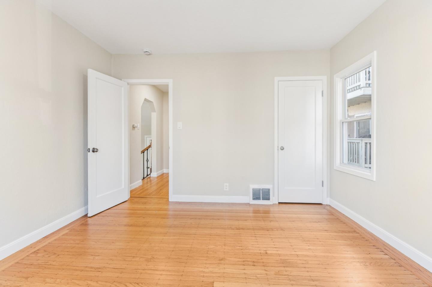136 Chester Street Daly City, CA 94014 - Photo 22 of 48 a view of an empty room with wooden floor and a window