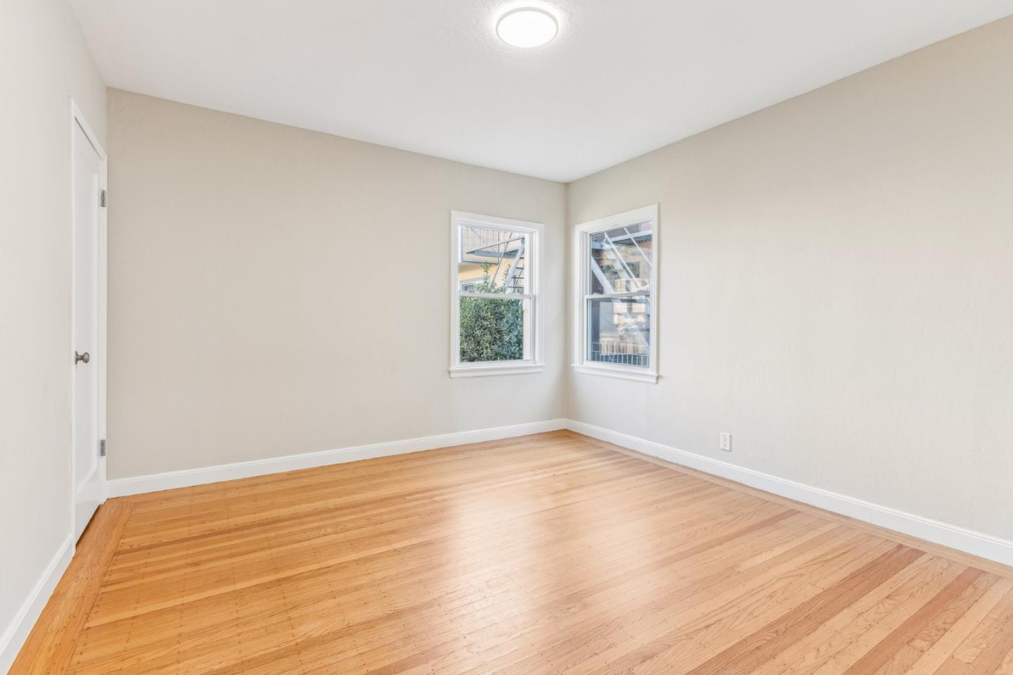 136 Chester Street Daly City, CA 94014 - Photo 24 of 48 a view of an empty room with wooden floor and a window