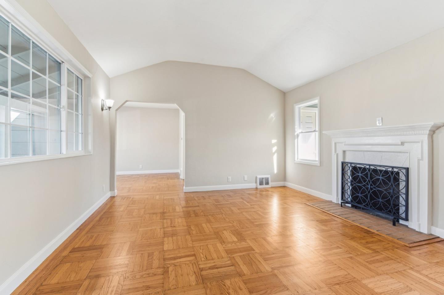 136 Chester Street Daly City, CA 94014 - Photo 9 of 48 a view of an empty room with a fireplace and a window