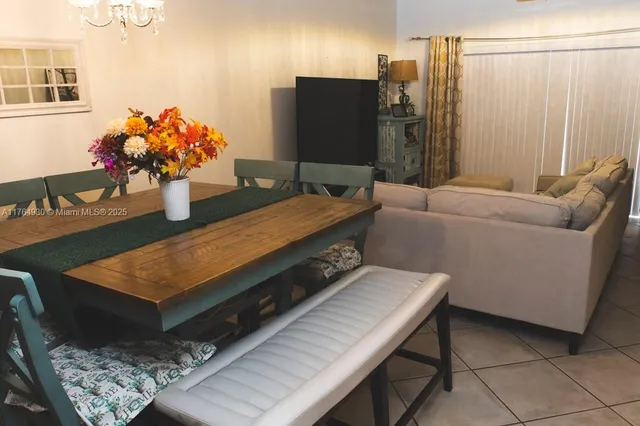 a living room with furniture and flowers