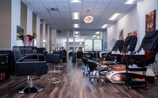 a living room with lots of chairs and a wooden floor