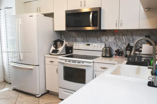 a kitchen with a stove and a refrigerator