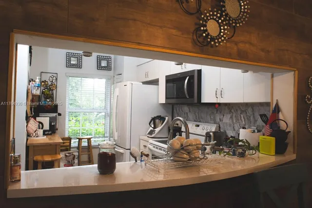 a kitchen with a sink a stove and cabinets
