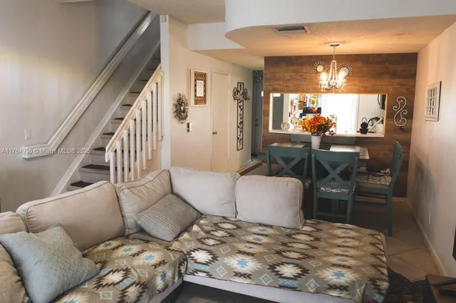 a living room with furniture and a dining table