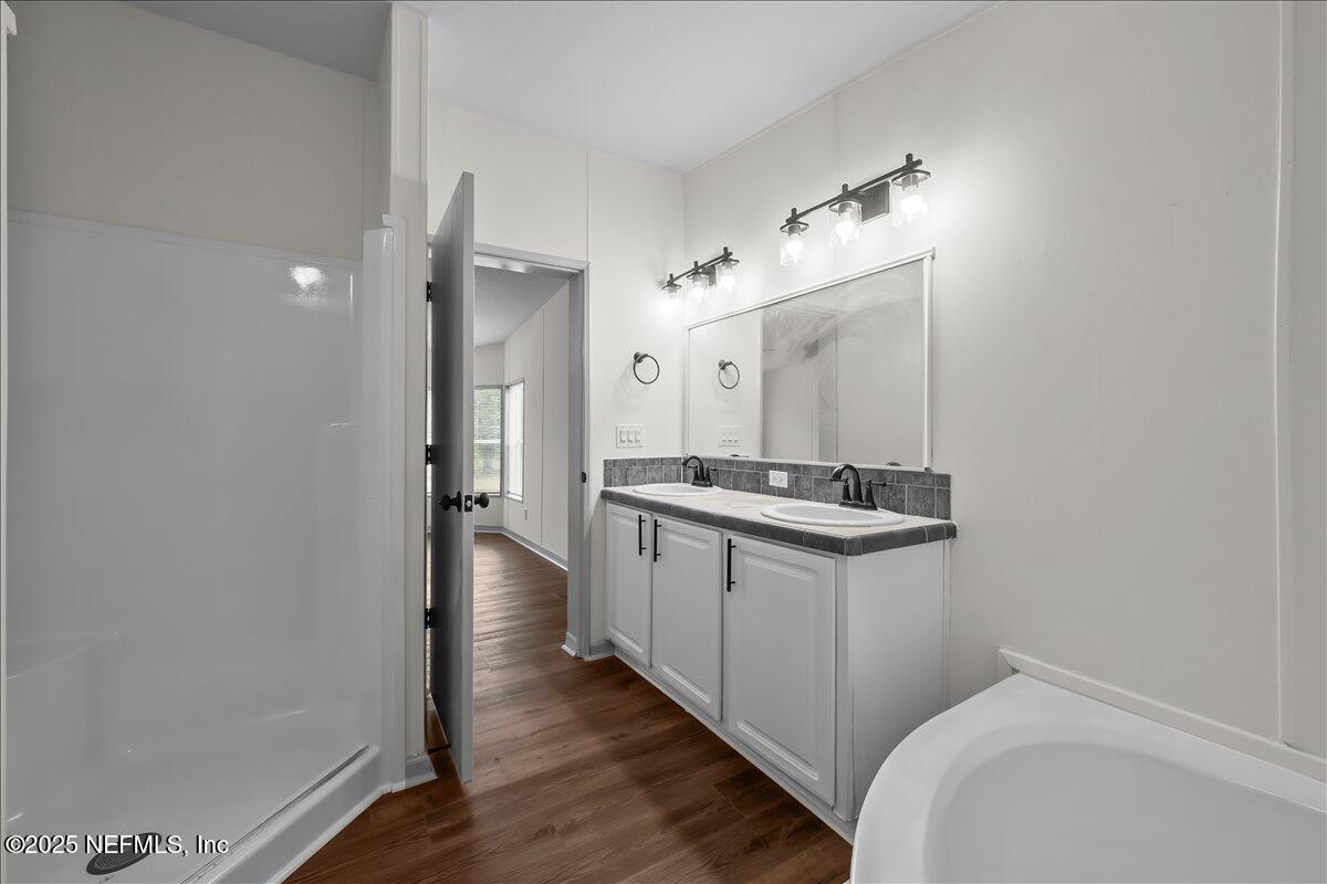 2929 Persimmon Street Bunnell, FL 32110 - Photo 12 of 28 a bathroom with a sink a mirror and a shower