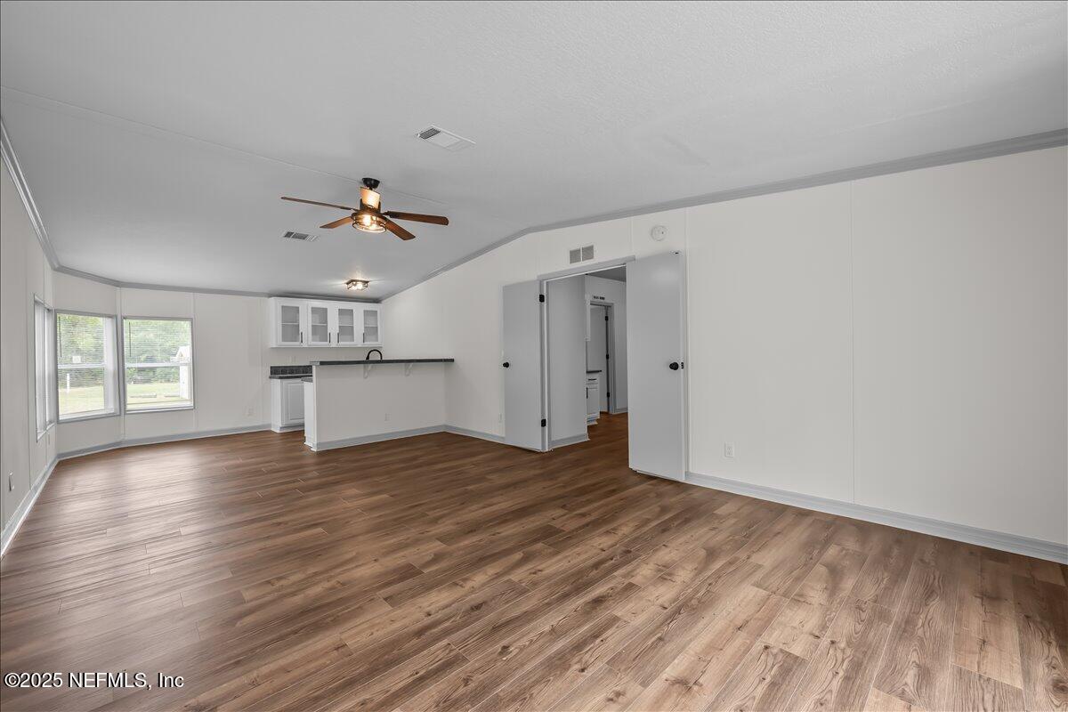 2929 Persimmon Street Bunnell, FL 32110 - Photo 21 of 28 a view of empty room with wooden floor and fan