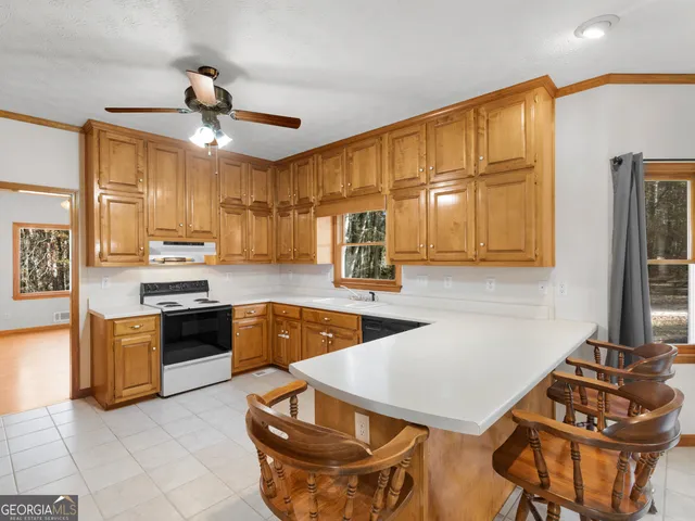 a kitchen with stainless steel appliances granite countertop a stove refrigerator and cabinets