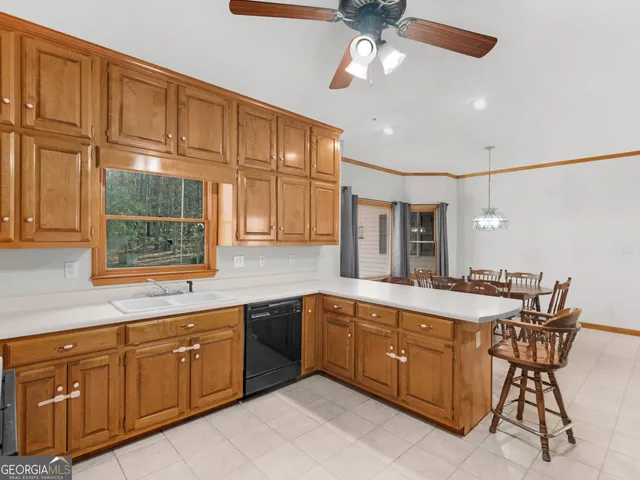 a spacious kitchen with stainless steel appliances granite countertop a sink and cabinets