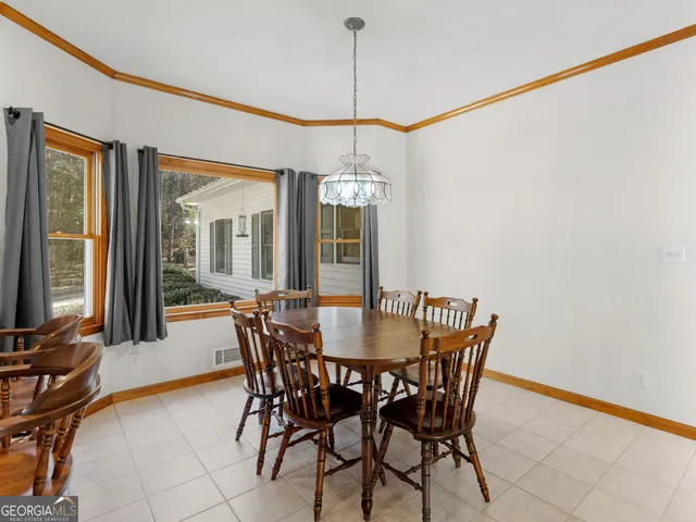 a view of a dining room with furniture and chandelier