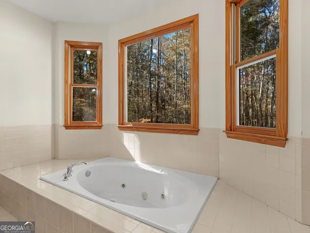 a white bath tub sitting next to a window