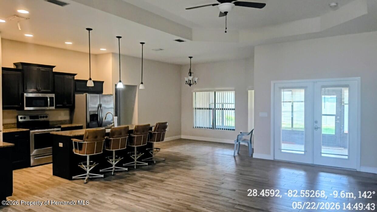 10244 Heathcliff Street Spring Hill, FL 34608 - Photo 9 of 30 a view of a kitchen with dining room and wooden floor