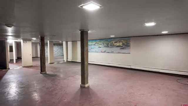 a view of a kitchen counter top a sink and cabinets