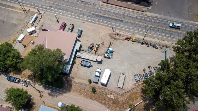 a view of a patio with dining table and chairs under an umbrella