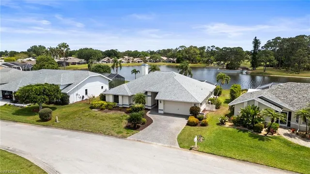 an aerial view of a house with a garden and lake view