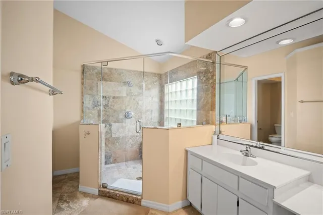 a bathroom with a double vanity sink mirror and shower