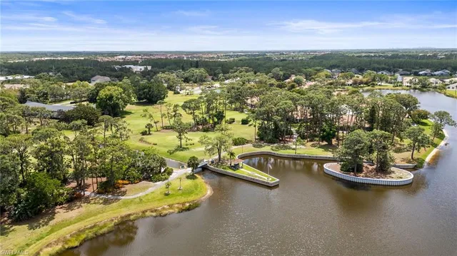 an aerial view of a swimming pool with outdoor seating