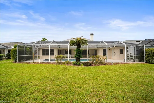 a view of a house with a big yard and potted plants