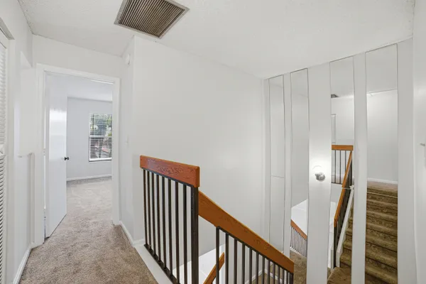 a view of a hallway with windows