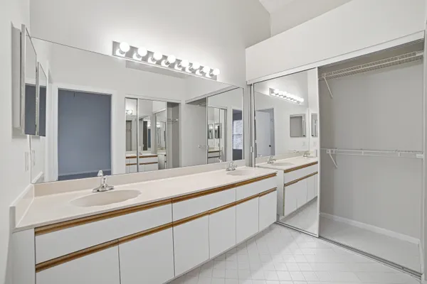 a spacious bathroom with a double vanity sink and a mirror