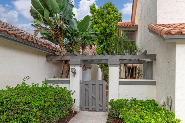 a front view of a house with plants