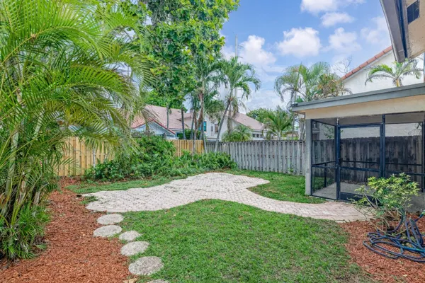 a view of a backyard with wooden fence