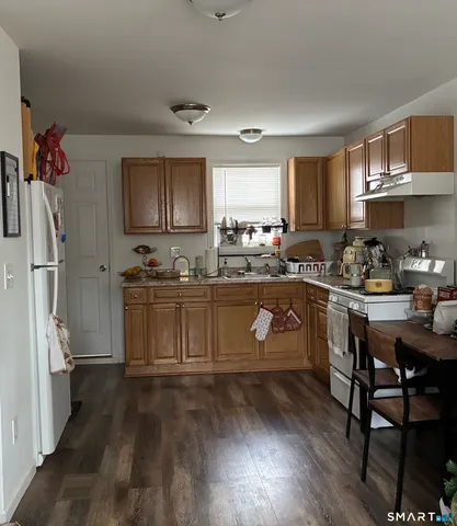 a kitchen with a sink refrigerator and cabinets