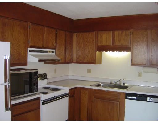 402 Paradise Road, Unit 402 2J Swampscott, MA 01907 - Photo 1 of 1 a kitchen with stainless steel appliances a stove a sink and a microwave