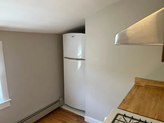 a view of a room with wooden floor