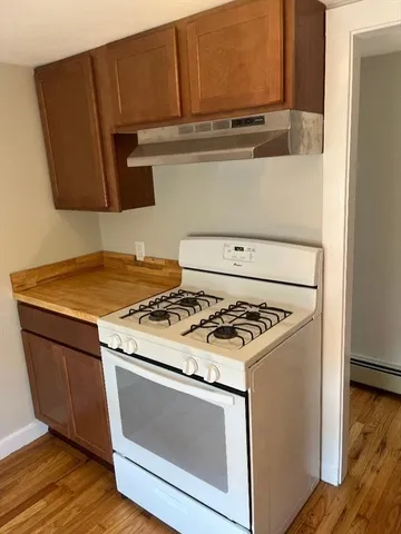 a stove top oven sitting inside of a kitchen