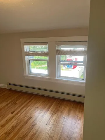 a view of an empty room and wooden floor