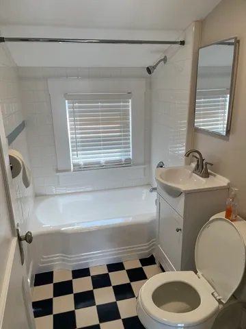 a bathroom with a toilet a sink and a bathtub