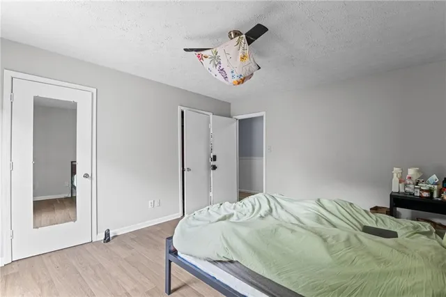 a bedroom with a bed and a chandelier