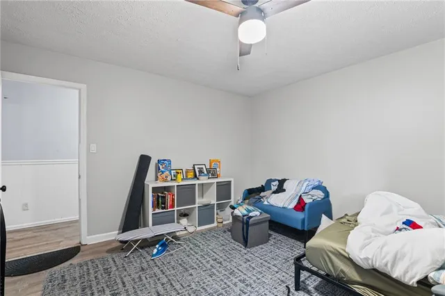 a bedroom with furniture and a book shelf