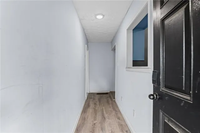 a view of a hallway with wooden floor
