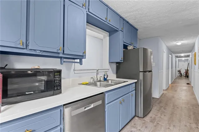 a kitchen with refrigerator and cabinets