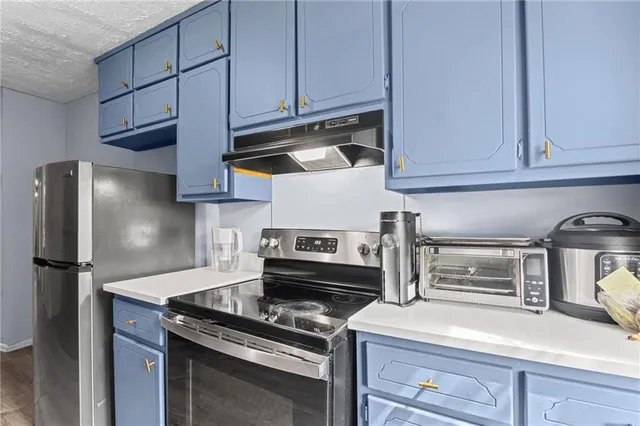 a kitchen with appliances cabinets and a counter top space